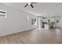 Bright, open-concept living room with hardwood floors leading to a modern, well-lit kitchen at 815 Goshen St, Oxford, NC 27565