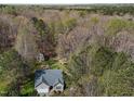 Picturesque aerial view showcasing the home, surrounded by lush trees and greenery in a secluded setting at 85 Rolling Cloud Dr, Louisburg, NC 27549