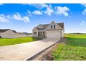 Charming home with a long driveway, neutral siding, a covered porch, and an attached two-car garage at 9744 Bear Run Ln, Middlesex, NC 27557