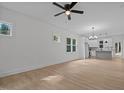 Spacious living area with light wood floors and lots of natural light from adjacent kitchen at 111 Halifax Rd, Louisburg, NC 27549
