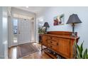 Welcoming foyer with hardwood floors, a console table, and front door with sidelights at 111 San Juan Dr, Chapel Hill, NC 27514