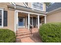 Charming covered front porch with brick steps and blue front door at 111 San Juan Dr, Chapel Hill, NC 27514