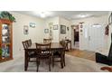 Inviting dining room with wood table set for six, adjacent to the entryway and hardwood flooring at 11821 Fairlie Pl, Raleigh, NC 27613
