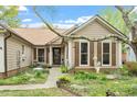 Charming exterior with inviting walkway, complemented by brown shutters and decorative landscaping features at 11821 Fairlie Pl, Raleigh, NC 27613