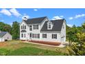 Attractive two-story home with black roof, manicured lawn and an attached garage at 1308 Aspen Falls Ct, Willow Springs, NC 27592
