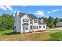 Beautiful two-story home with well-maintained lawn and mature trees surrounding the property at 1308 Aspen Falls Ct, Willow Springs, NC 27592