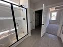 Modern bathroom featuring a glass door shower and an open closet with ample storage space at 141 Ruskin Dr, Smithfield, NC 27577