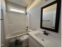 Bright bathroom with a tub shower combo, a white vanity, and black fixtures at 141 Ruskin Dr, Smithfield, NC 27577