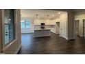 Modern kitchen with white cabinets, granite countertops, stainless appliances, and dark hardwood floors at 141 Ruskin Dr, Smithfield, NC 27577