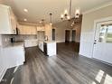 Bright, open kitchen with white cabinetry, an island, and stainless steel appliances at 141 Ruskin Dr, Smithfield, NC 27577