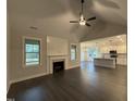 Open concept living room boasts a fireplace, vaulted ceiling and access to the kitchen and dining area at 141 Ruskin Dr, Smithfield, NC 27577
