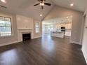 Spacious living room with hardwood floors, a fireplace, and an open view to the kitchen at 141 Ruskin Dr, Smithfield, NC 27577