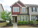 Inviting two-story home showcasing a well-manicured lawn and a cozy front porch at 1725 Mallard Trace Dr, Wendell, NC 27591