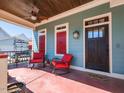 Relaxing covered front porch with rocking chairs, ceiling fan, and a charming 'hello' doormat at 1980 Great Ridge Pkwy, Chapel Hill, NC 27516
