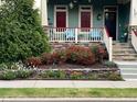 Inviting front porch with decorative railing and stone accents surrounded by lush landscaping at 1980 Great Ridge Pkwy, Chapel Hill, NC 27516