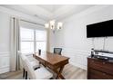 Bright home office with crown molding, large window, wood floors, and modern chandelier at 206 Drayton Hall Ln, Sanford, NC 27330