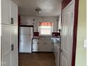 Charming kitchen featuring white cabinetry, modern appliances, and a window with a view at 2102 Michael Ln, Smithfield, NC 27577