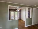 View of a living room with French doors leading to the porch, wood floors, and colorful walls at 2102 Michael Ln, Smithfield, NC 27577