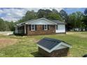 View of house showing brick and white siding exterior with black roof at 2130 Pearidge Rd, Angier, NC 27501