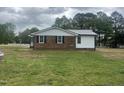 Side view of the home with white siding and black shutters at 2130 Pearidge Rd, Angier, NC 27501