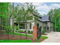 Beautiful home with a mix of stone and painted siding, complemented by professional landscaping at 2200 Paddstowe Main Way, Wake Forest, NC 27587