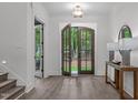Inviting foyer with hardwood floors, double doors, and views of the outdoors at 2200 Paddstowe Main Way, Wake Forest, NC 27587