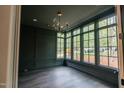 Stylish living room with expansive windows and modern lighting fixtures at 2200 Paddstowe Main Way, Wake Forest, NC 27587