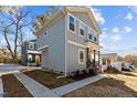 Two-story home showcasing light gray siding and manicured landscaping at 2207 Otis St # B, Durham, NC 27707