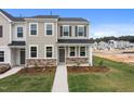 Beautiful townhome exterior with stone accents, tidy lawn, and welcoming entrance at 2313 Kasota Ln, Raleigh, NC 27610