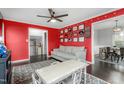 Another view of the spacious bonus room featuring bright red walls and multiple doorways at 2319 Somers Ave, Burlington, NC 27215