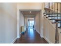 Elegant foyer with hardwood floors, staircase with wrought iron railing, and views to the living space at 2620 Club Level Dr, Apex, NC 27523