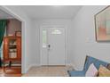 Bright foyer featuring neutral walls, tile flooring, and a decorative glass front door at 2808 Newquay St, Durham, NC 27705