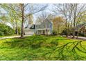 Charming two-story home with a manicured lawn, attached garage, and a lovely front porch at 2868 Anfield Rd, Raleigh, NC 27606