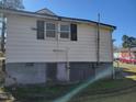 Exterior back view shows the siding, windows with shutters, and details around the foundation at 307 Watson St, Creedmoor, NC 27522