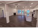 Bright living space with fireplace, wood floors, and lots of windows looking out on the front yard at 32 Tanseyleaf Dr, Smithfield, NC 27577