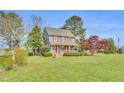 Charming two-story home featuring blue siding, red shutters and a cozy front porch at 3808 Johnson Pond Rd, Apex, NC 27539