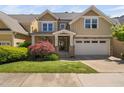 Charming two-story home with a manicured lawn and a stone-accented facade at 4121 Enfield Ridge Dr, Cary, NC 27519