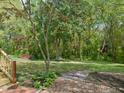 Backyard features a brick walkway and lush landscaping, perfect for enjoying nature at 4508 Fox Rd, Raleigh, NC 27616