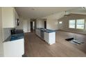 Modern kitchen with a large island, white cabinets, and stainless steel appliances at 47 Silver Ct, Smithfield, NC 27577