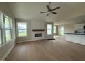 Bright living room with hardwood floors, a fireplace and large windows at 47 Silver Ct, Smithfield, NC 27577