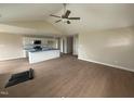 Open-concept living room and kitchen area, featuring wood-look floors and a ceiling fan at 47 Silver Ct, Smithfield, NC 27577