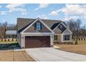 Charming home with brown garage door, light siding, and long driveway at 48 Tanseyleaf Dr, Smithfield, NC 27577