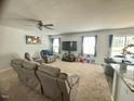 Spacious living room with plush seating, ceiling fan, and access to the dining area at 50 Teal Dr, Youngsville, NC 27596