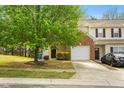 Charming townhome with one-car garage and landscaping and mature tree in the front yard at 528 Summer Storm Dr, Durham, NC 27704