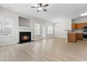 Bright open-concept living room features a fireplace, modern fan, and views of the kitchen at 528 Summer Storm Dr, Durham, NC 27704