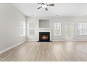 Spacious living room features a cozy fireplace, natural light, and new hardwood floors at 528 Summer Storm Dr, Durham, NC 27704