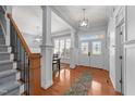 Bright foyer with hardwood floors, decorative front door, and staircase at 5317 Serather Ct, Garner, NC 27529