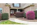 Inviting front porch with a decorative front door and manicured shrubbery at 5317 Serather Ct, Garner, NC 27529