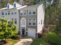 Townhome features neutral siding, attached garage, driveway, and mature landscaping at 5430 Crabtree Park Ct, Raleigh, NC 27612