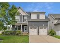 Charming two-story home with a two-car garage, nicely landscaped yard, and inviting blue entry door at 706 Fireball Ct, Knightdale, NC 27545